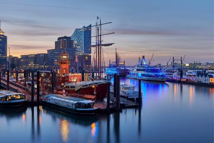 Hamburg HafenCity waterfront with boats and Elbphilharmonie at dusk, highlights self-guided scavenger hunt tour