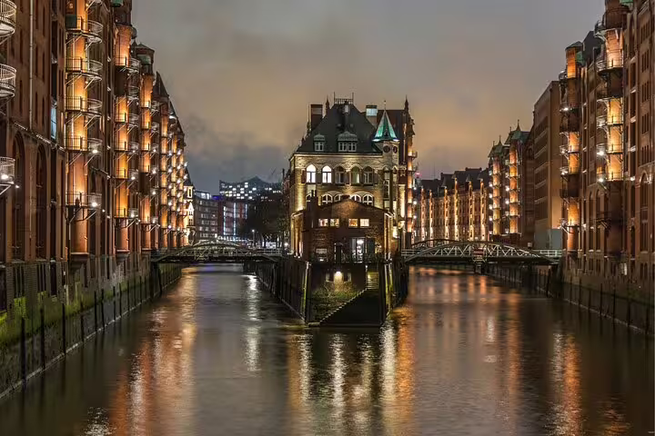 Illuminated Speicherstadt canals at dusk in Hamburg, key stop on a self-guided scavenger hunt tour