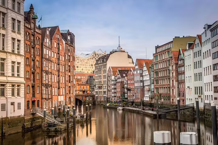 Hamburg waterfront canal lined with colorful historic buildings and the Elbphilharmonie in the background