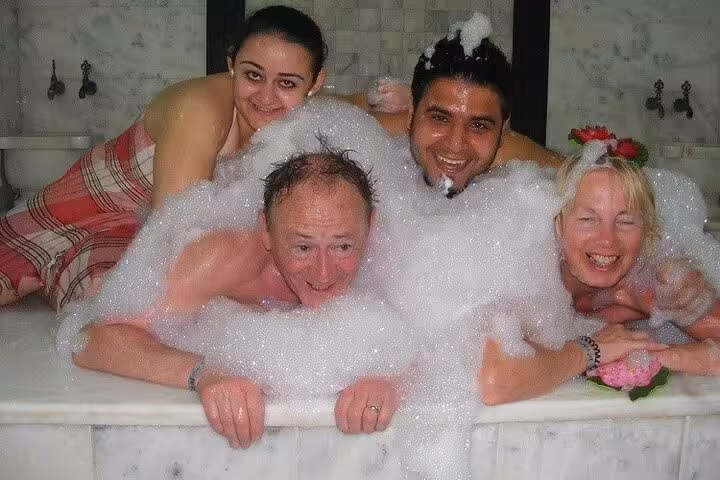 Group enjoying foam bath in Turkish hammam spa, part of 120-minute relaxation package in Sharm El Sheikh