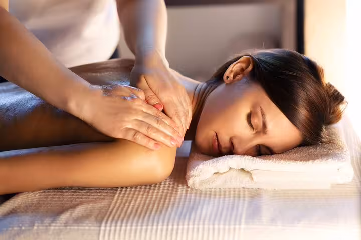 Woman receiving deep tissue back massage on spa bed during 120-minute hammam session in Sharm El Sheikh