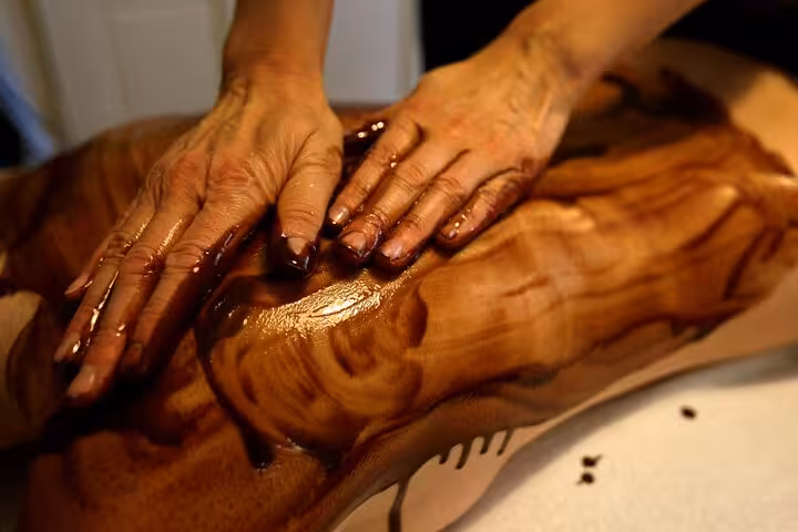 Therapist hands apply aromatic oil massage on back at Sharm El Sheikh hammam spa, 120-minute wellness session