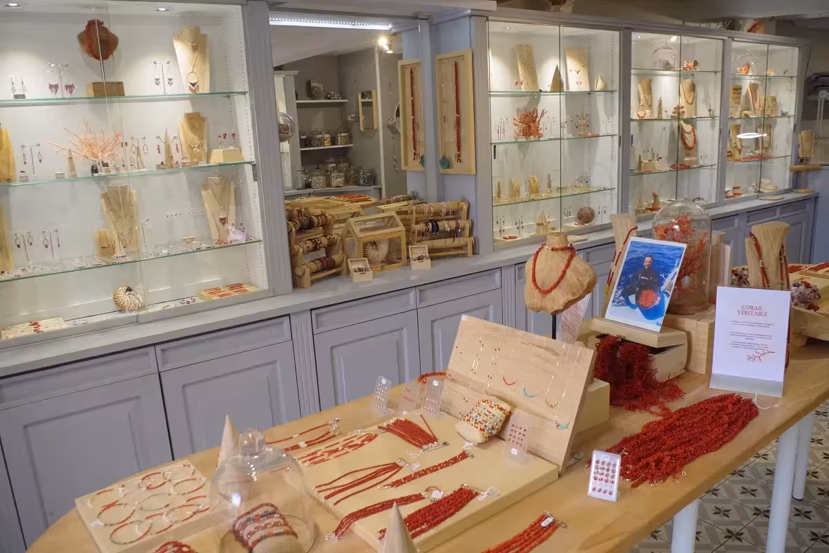 Handmade coral jewelry and artisan crafts display in an old district shop stop on the craft and wine tour