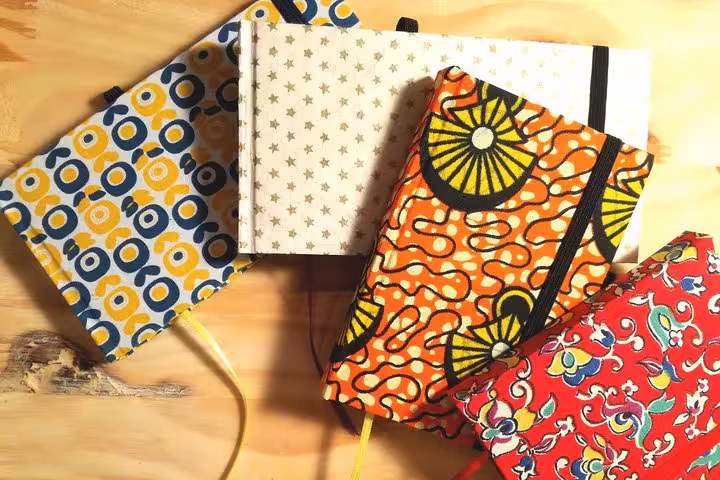 Colorful handmade journals with elastic bands, crafted during a Vieux Port Marseille bookbinding experience