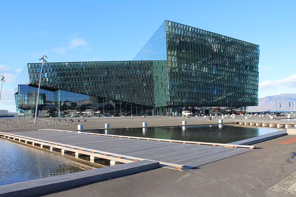 Harpa Concert Hall iconic glass facade reflecting Reykjavik harbor on a private city tour of Iceland