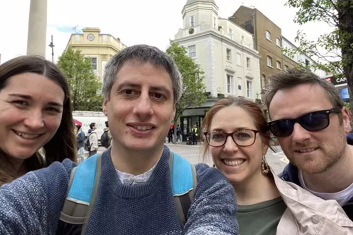 Four smiling adults posing for a selfie on a London street during a Harry Potter walking tour