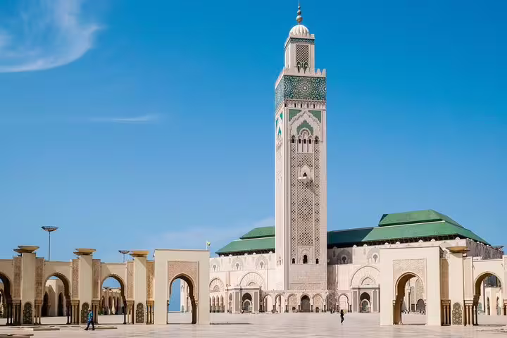 Hassan II Mosque exterior in Casablanca on a private day trip, showcasing minaret, arches and oceanfront plaza