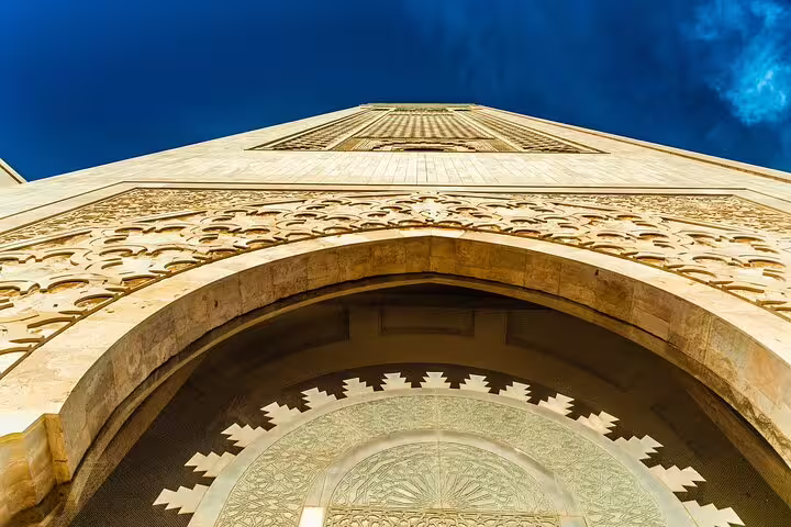 Close-up of Hassan II Mosque entrance arch and carvings, a highlight of the Private Casablanca Day Trip Through Time