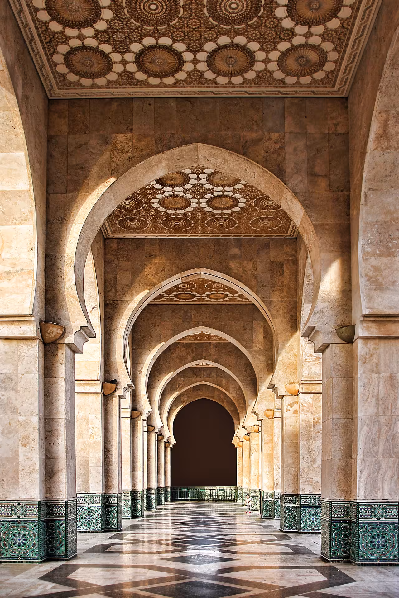 Arched corridor with zellige tiles at Hassan II Mosque, Casablanca, Timeless Morocco highlights tour