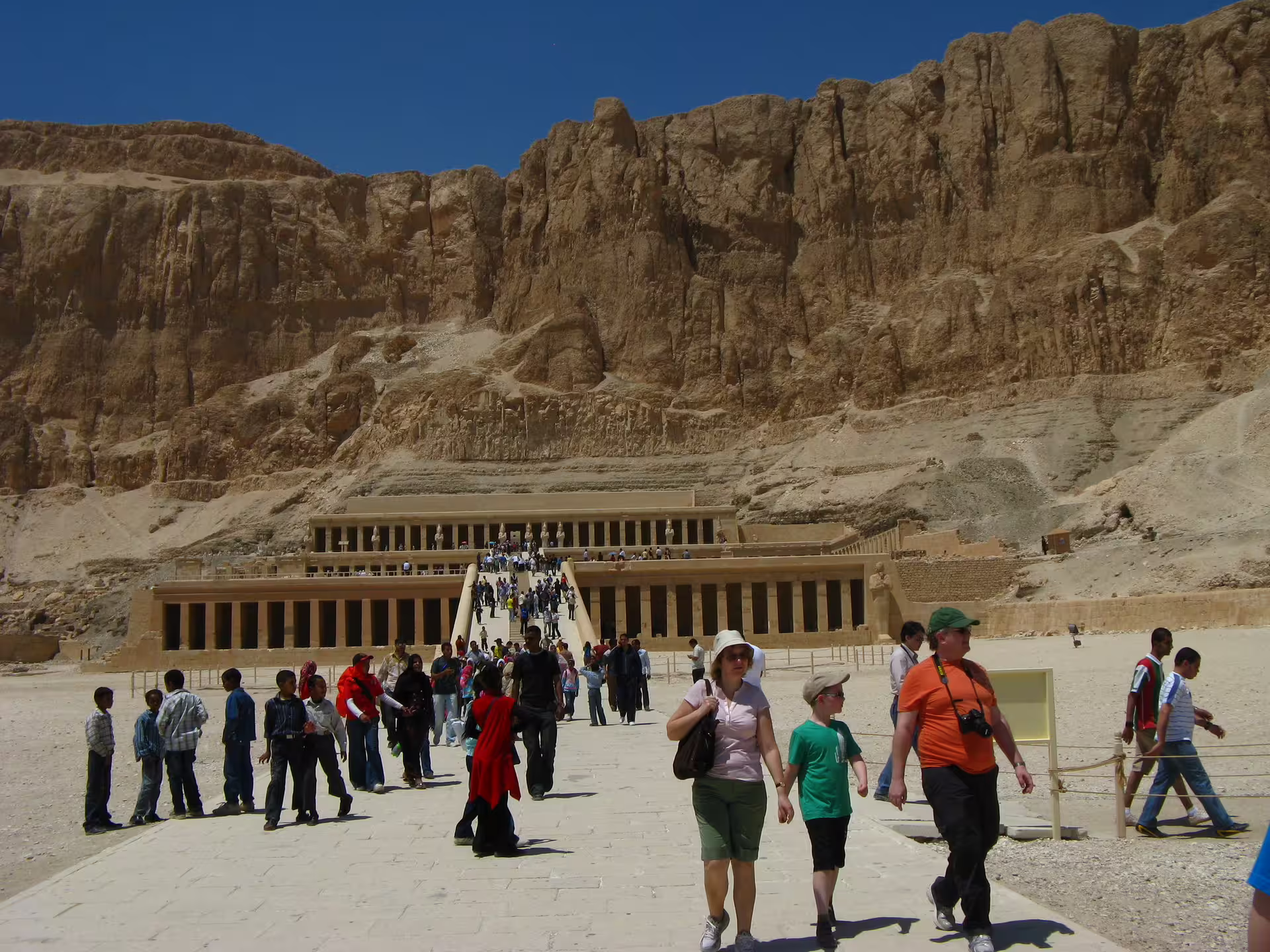 Tourists walking to Hatshepsut Temple at Deir el-Bahari, key stop on Luxor overday minibus trip from Hurghada