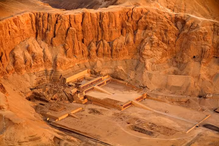 Aerial view of Hatshepsut Temple at Deir el-Bahari cliffs, Luxor stop on 7-day Cairo Luxor Aswan tour