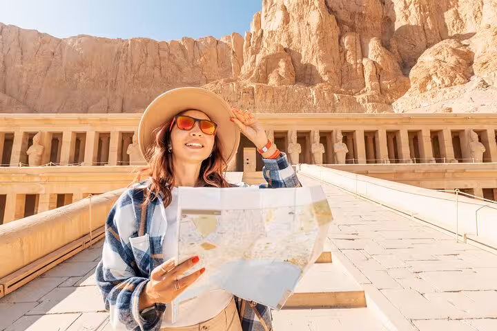 Visitor with map at Hatshepsut Temple, West Bank Luxor, on Cairo to Luxor by plane small group tour
