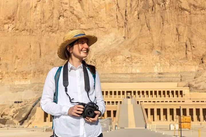 Tourist with camera at Hatshepsut Temple, Luxor excursion from Marsa Alam to Valley of the Kings