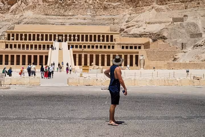 Traveler facing Hatshepsut Temple in Luxor, Egypt on Marsa Alam to Valley of the Kings and Karnak day tour
