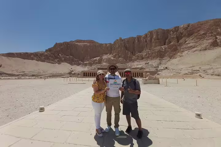 Visitors pose at Hatshepsut Temple in Luxor West Bank desert, part of Luxor full-day tour itinerary