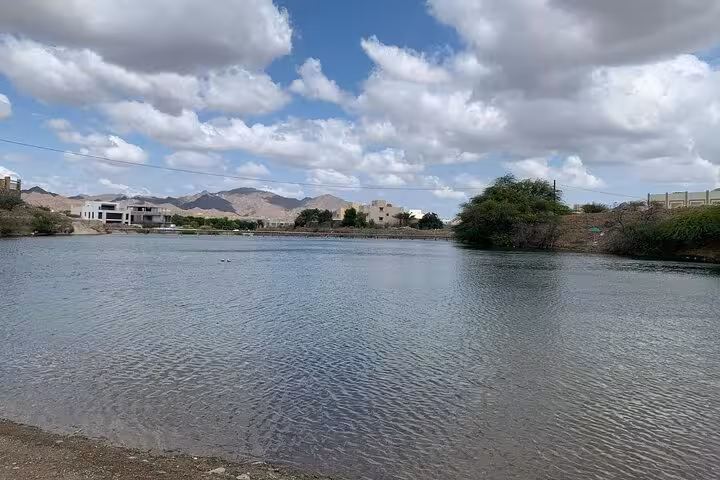 Calm Hatta Lake views on a private full-day Hatta tour, scenic water and mountains near Hatta Dam UAE