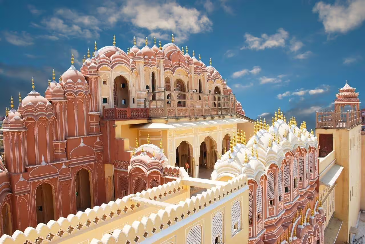 Stunning view of Hawa Mahal's intricate architecture against a blue sky, featured in Golden Triangle tour.