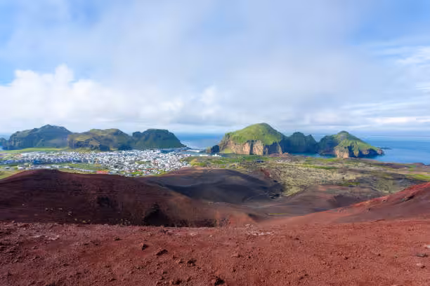Aerial view of Heimaey town and green volcanic islands from Eldfell crater, Westman Islands, Iceland