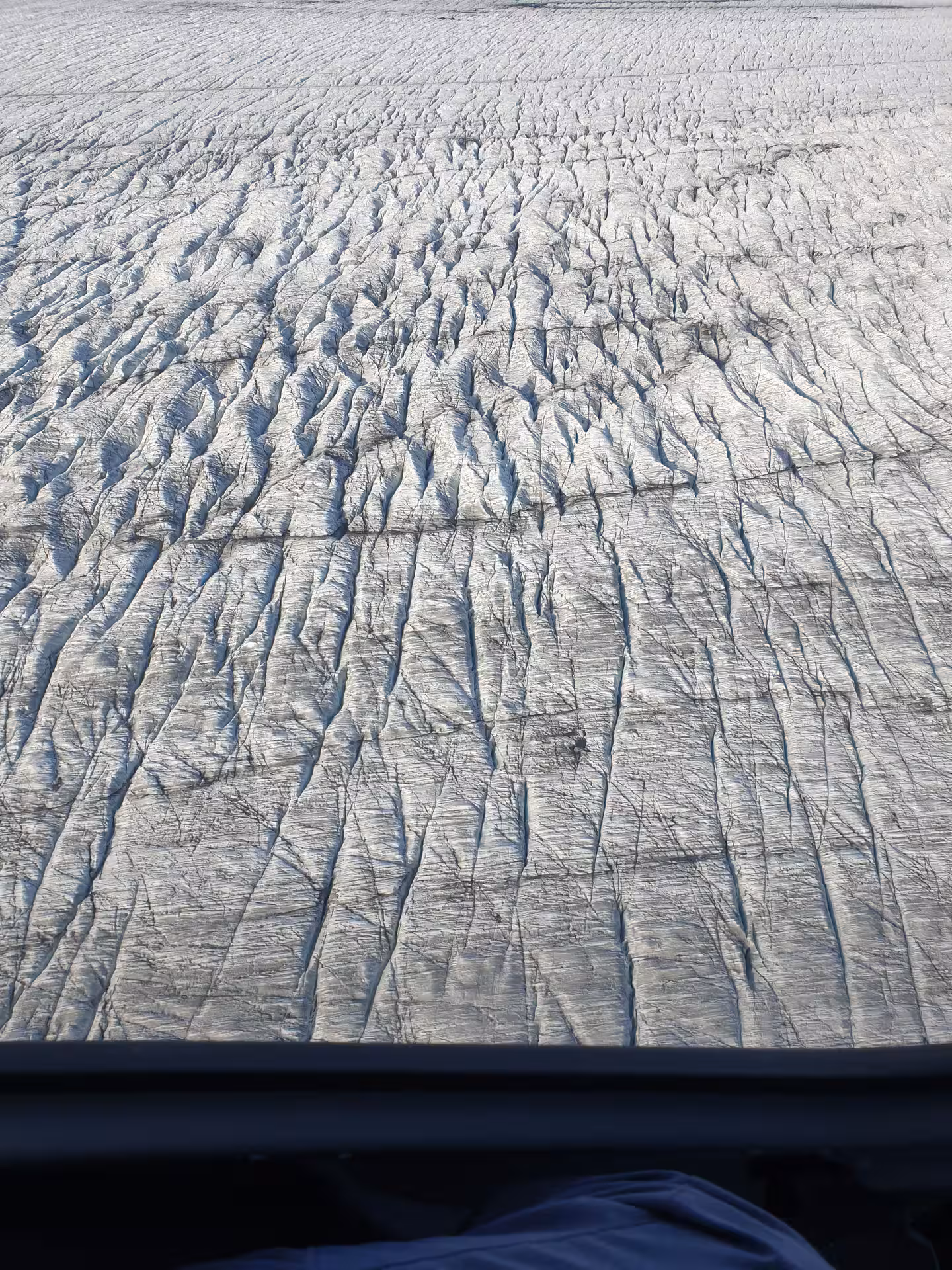Aerial view of a heavily crevassed glacier surface in Skaftafell, Iceland, seen from a helicopter