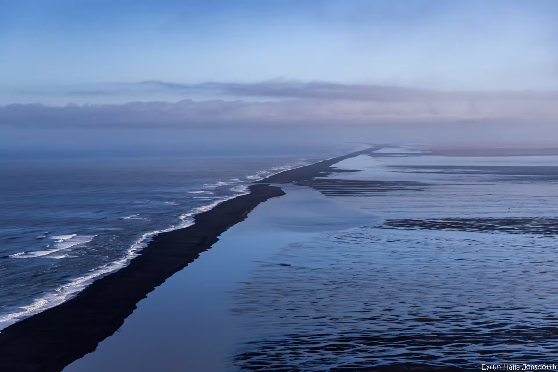 Aerial view of Iceland's black sand beach coastline stretching to the horizon near Skaftafell
