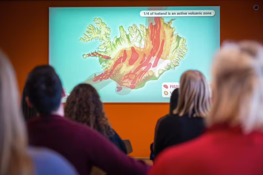 Visitors engage with an educational display of Iceland's geothermal activity at the Hellisheidi Geothermal Exhibition.
