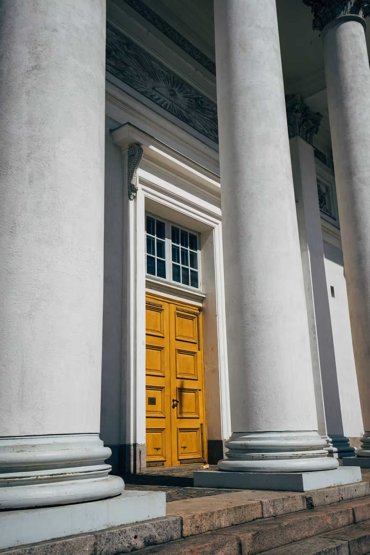 Close-up of Helsinki Cathedral's elegant columns and detailed entrance, a must-see for architecture tours in Finland.