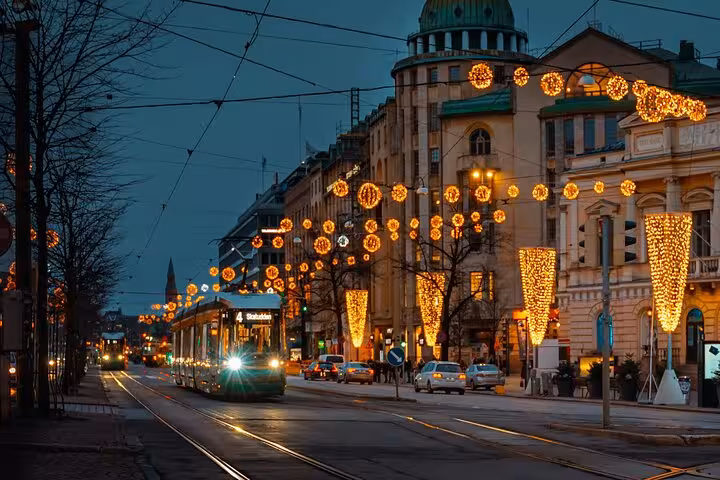 Evening tram in Helsinki glides through streets adorned with festive lights, ideal for a sociologist walking tour.