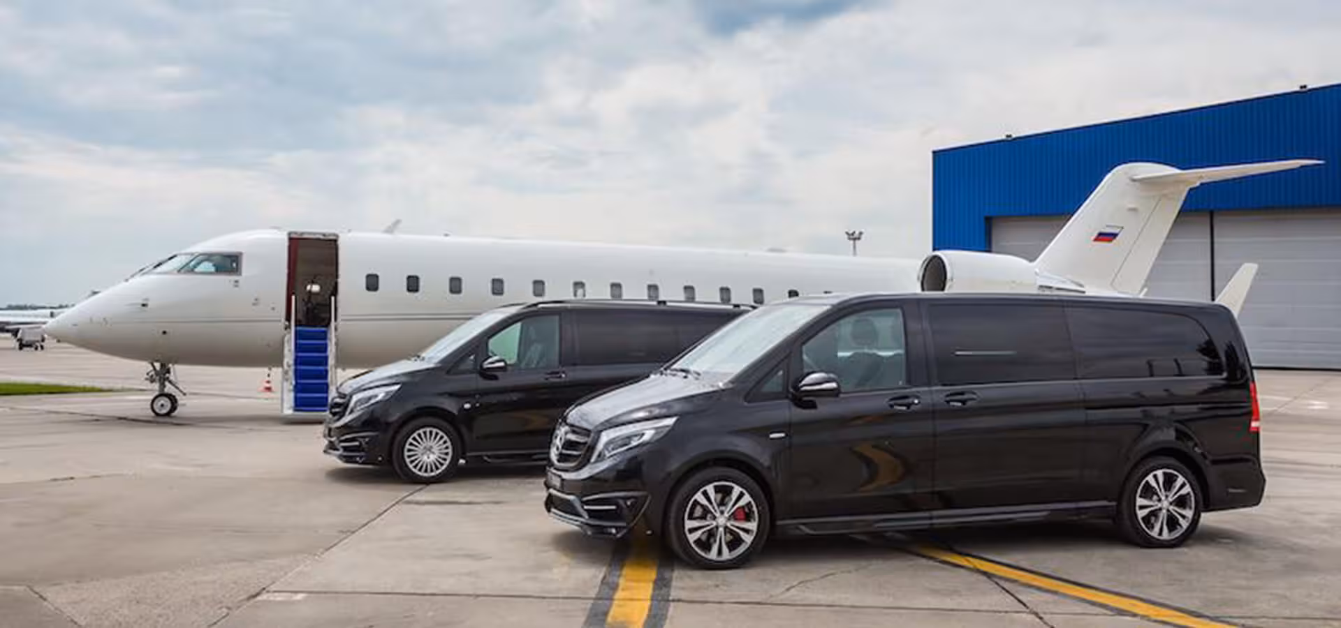 Executive vans beside private jet for Heraklion Airport to Sfakia and Frangokastello transfer, Crete