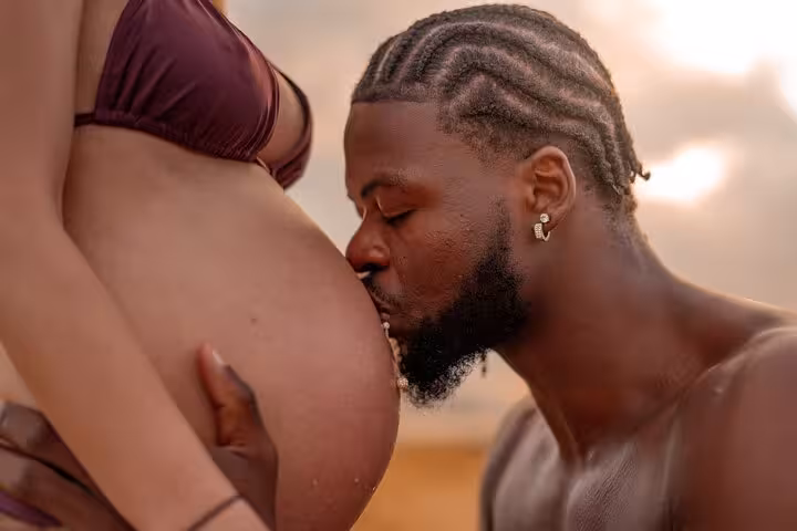 Close-up of a tender moment during a Heraklion maternity shoot, highlighting love and anticipation by the sea.