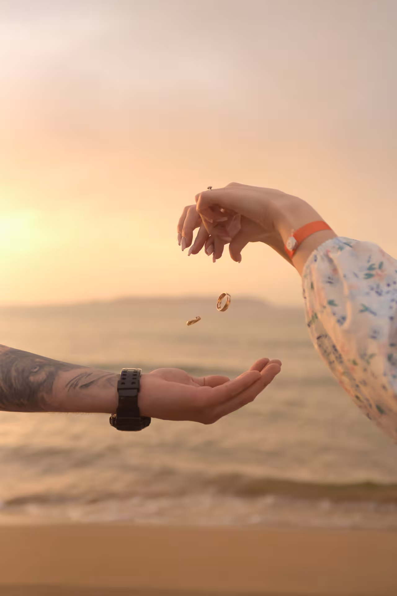 Close-up of hands exchanging rings at sunset during a Heraklion Venetian Port proposal shoot.
