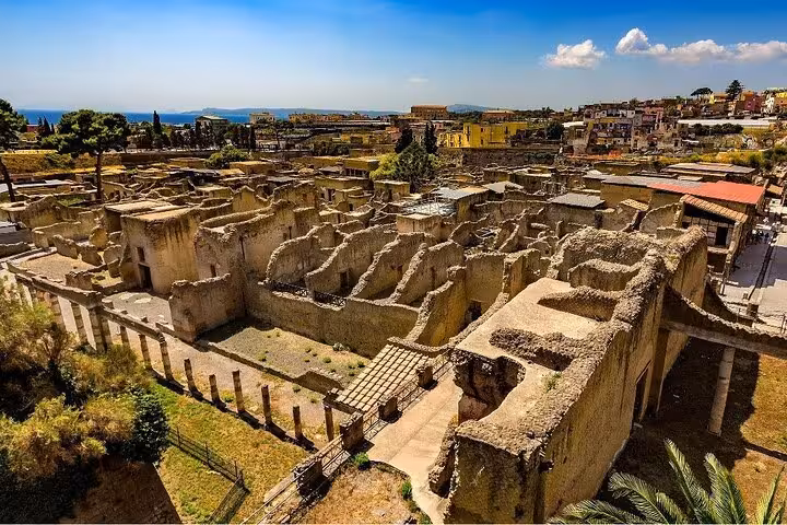 Explore the ancient ruins of Herculaneum with stunning views, part of the Pompeii and Herculaneum skip-the-line tour.