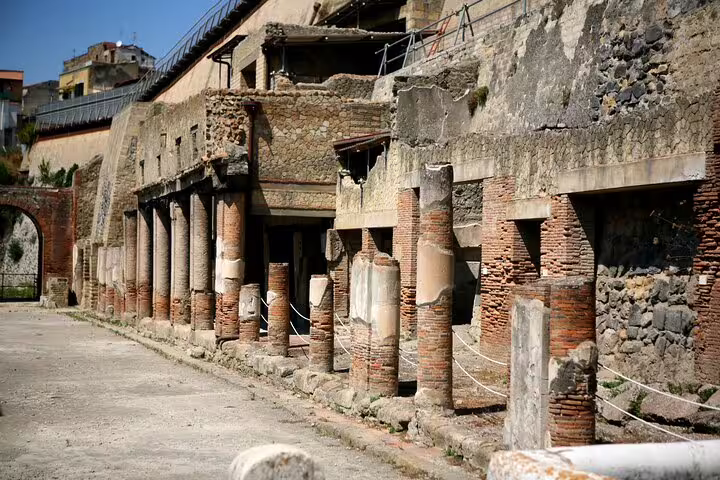 Ancient colonnaded street in Herculaneum archaeological site explored on a private guided tour from Naples, Italy