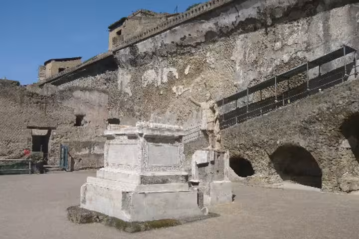 Ancient marble altar and stone walls in Herculaneum, a key stop on the Ercolano Mount Vesuvius history and wine tour
