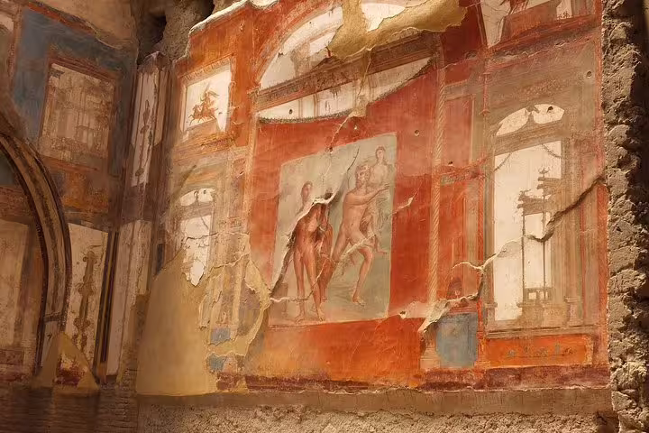 Ancient Roman fresco inside Herculaneum ruins, highlight of guided Herculaneum tour from Naples