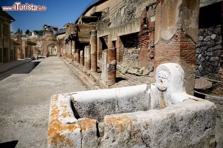 Ancient Roman street and stone fountain in the archaeological site of Herculaneum on the Ercolano shore excursion tour