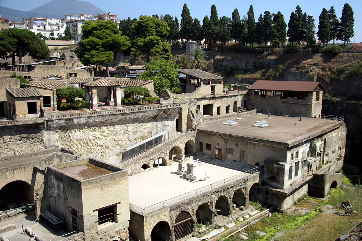 Panoramic view of Herculaneum archaeological ruins with Mount Vesuvius in the background on a guided daily tour from Naples