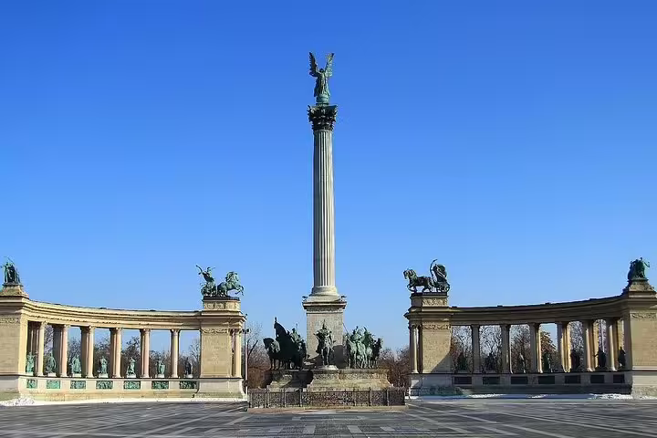 Hero's Square in Budapest, featuring iconic statues and a central column, a highlight on a private day trip from Vienna.