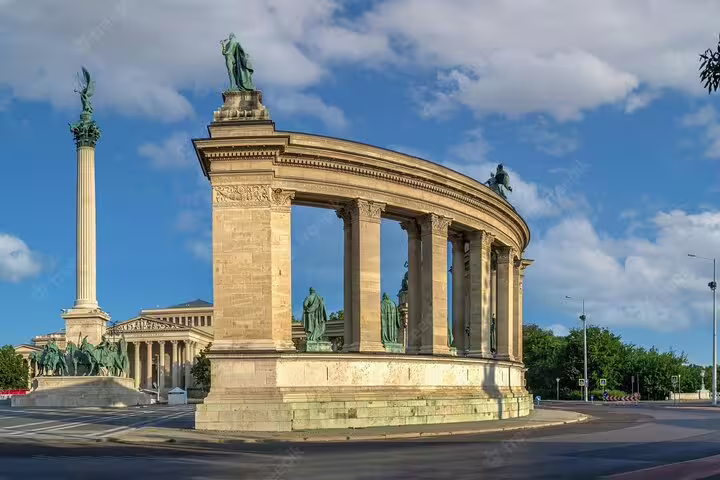 Heroes' Square colonnade with statues and Millennium Monument column in Budapest, Hungary