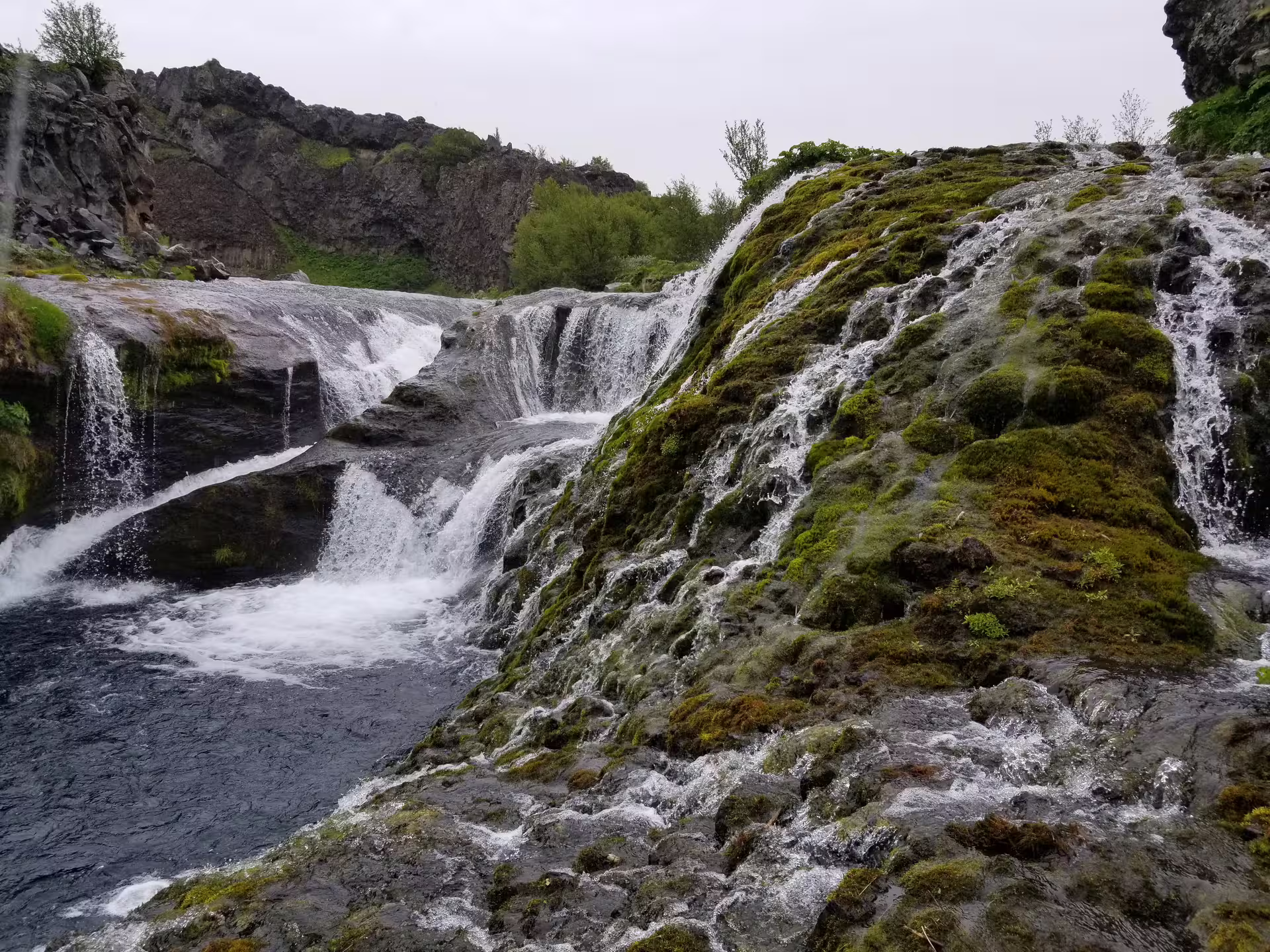 Moss-covered lava rocks with cascading hidden waterfalls discovered on a private super jeep Iceland off-road adventure tour