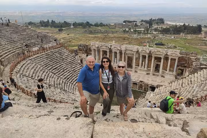 Visitors at Hierapolis Roman theatre on a private Pamukkale tour from Denizli Airport with guide