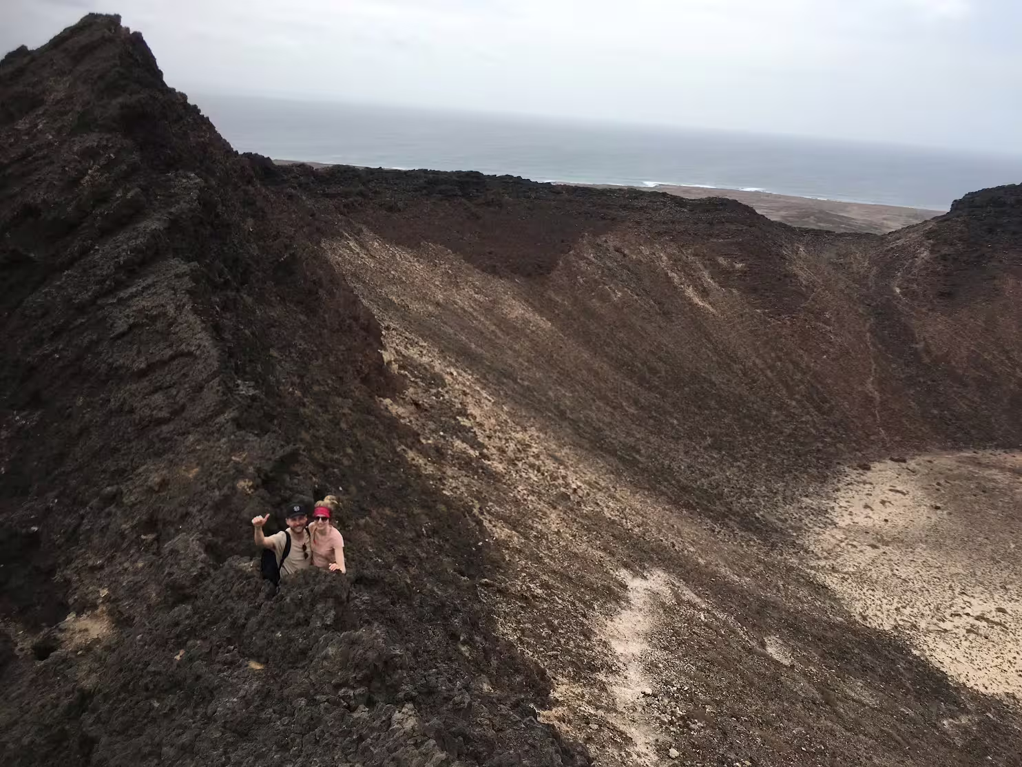 Hikers enjoy breathtaking views on the rugged terrain of Volcano Viana in São Vicente, an ideal spot for adventurous trekking.