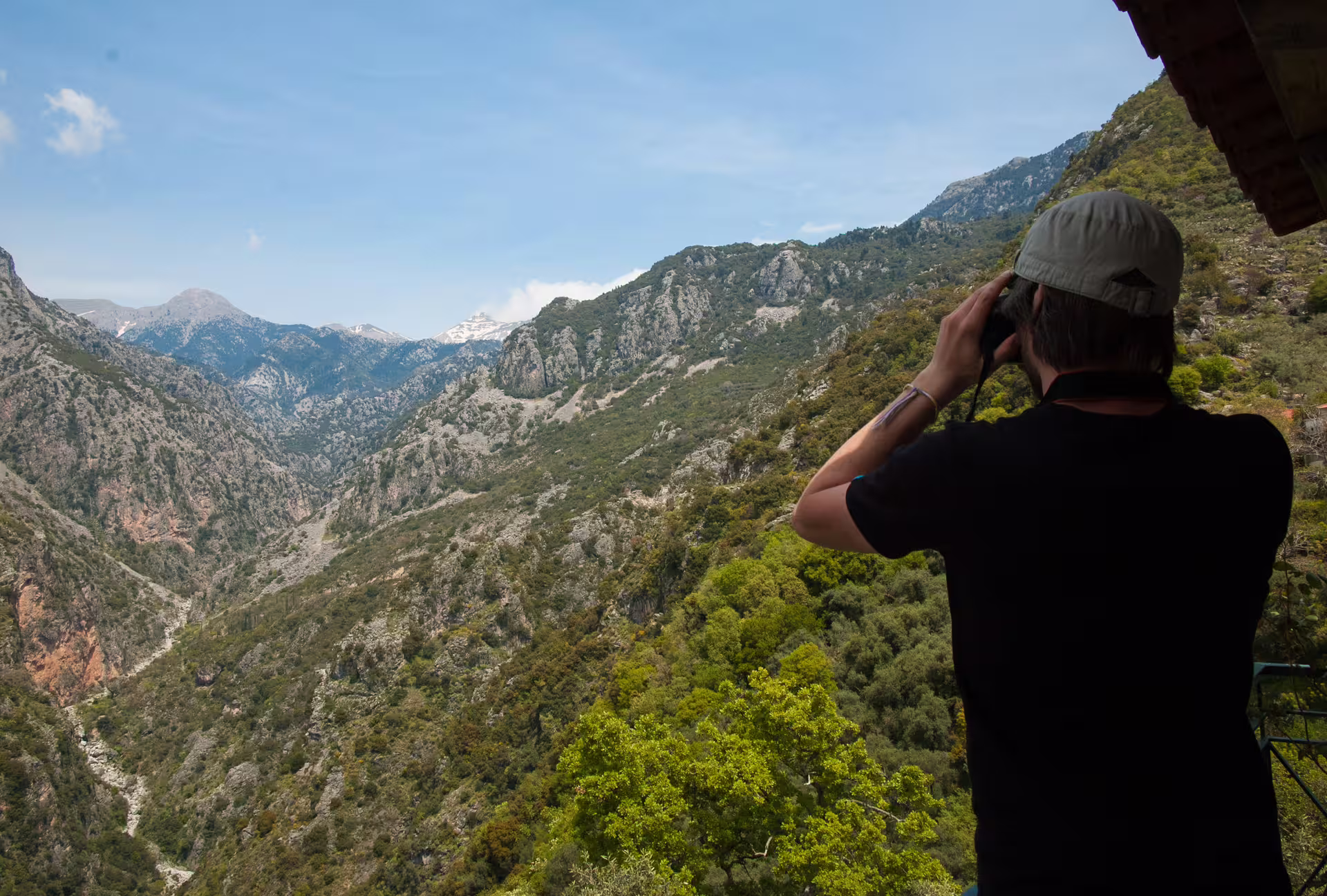 Hiker overlooks Taygetos Mountains near Kardamyli on guided hiking tour in Mani, Peloponnese, Greece
