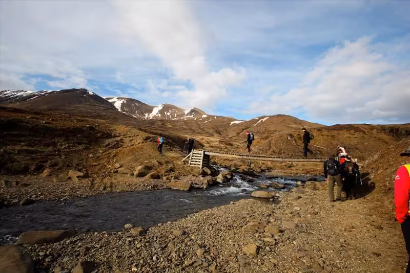 Hikers crossing a bridge