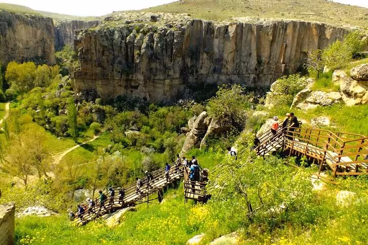 Hikers on wooden stairs in Ihlara Valley canyon, Cappadocia Green Tour full-day nature walk viewpoint