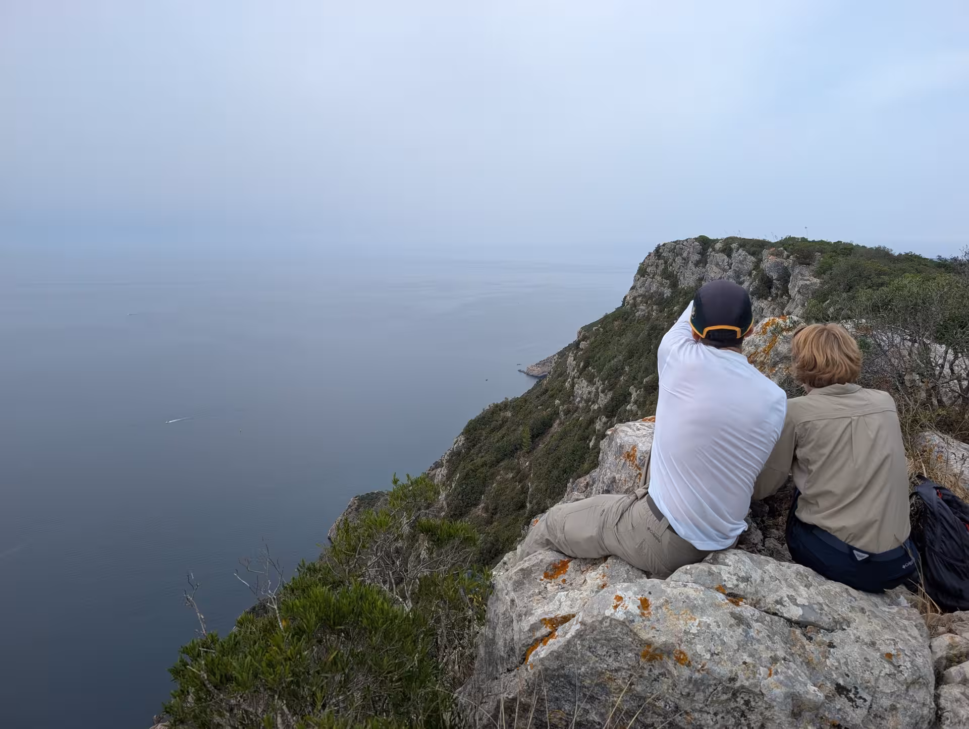 Hikers resting on Cabo da Roca sea cliffs, view from the highest cliff of continental Europe hike in Portugal