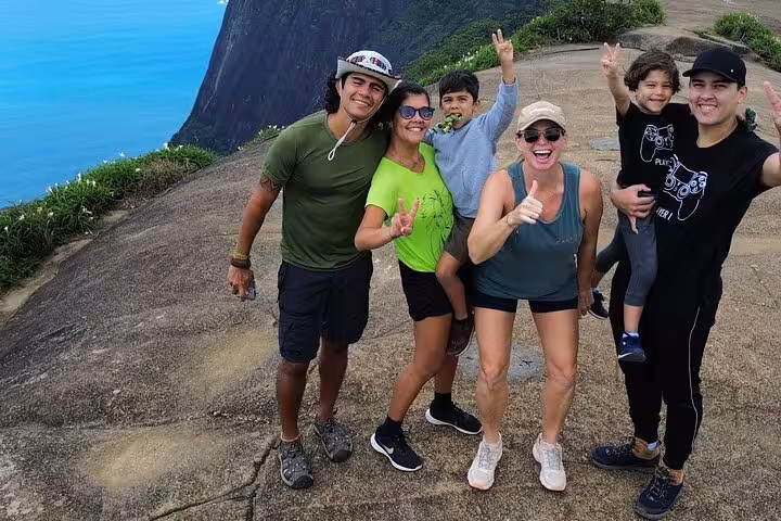 Group of hikers celebrating stunning vistas on the Trail to Beautiful Stone, DA Tijuca Forest.