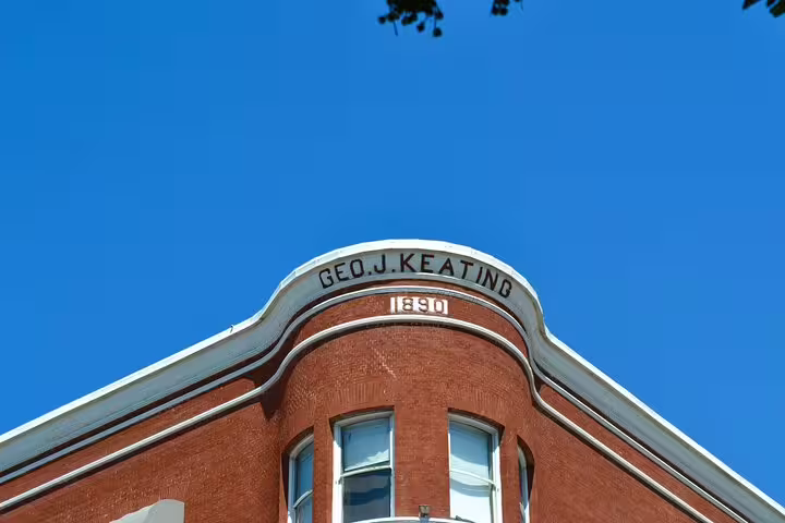 Historic 1890 Geo J. Keating red brick building corner with curved facade in San Diego
