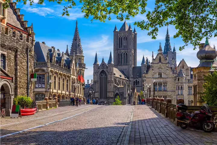 Cobblestone street leading to Saint Nicholas Church in historic Ghent city center, Belgium