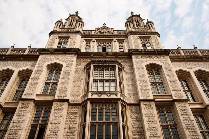 Gothic Tudor architecture of a historic London building facade with ornate stone detailing and mullioned windows