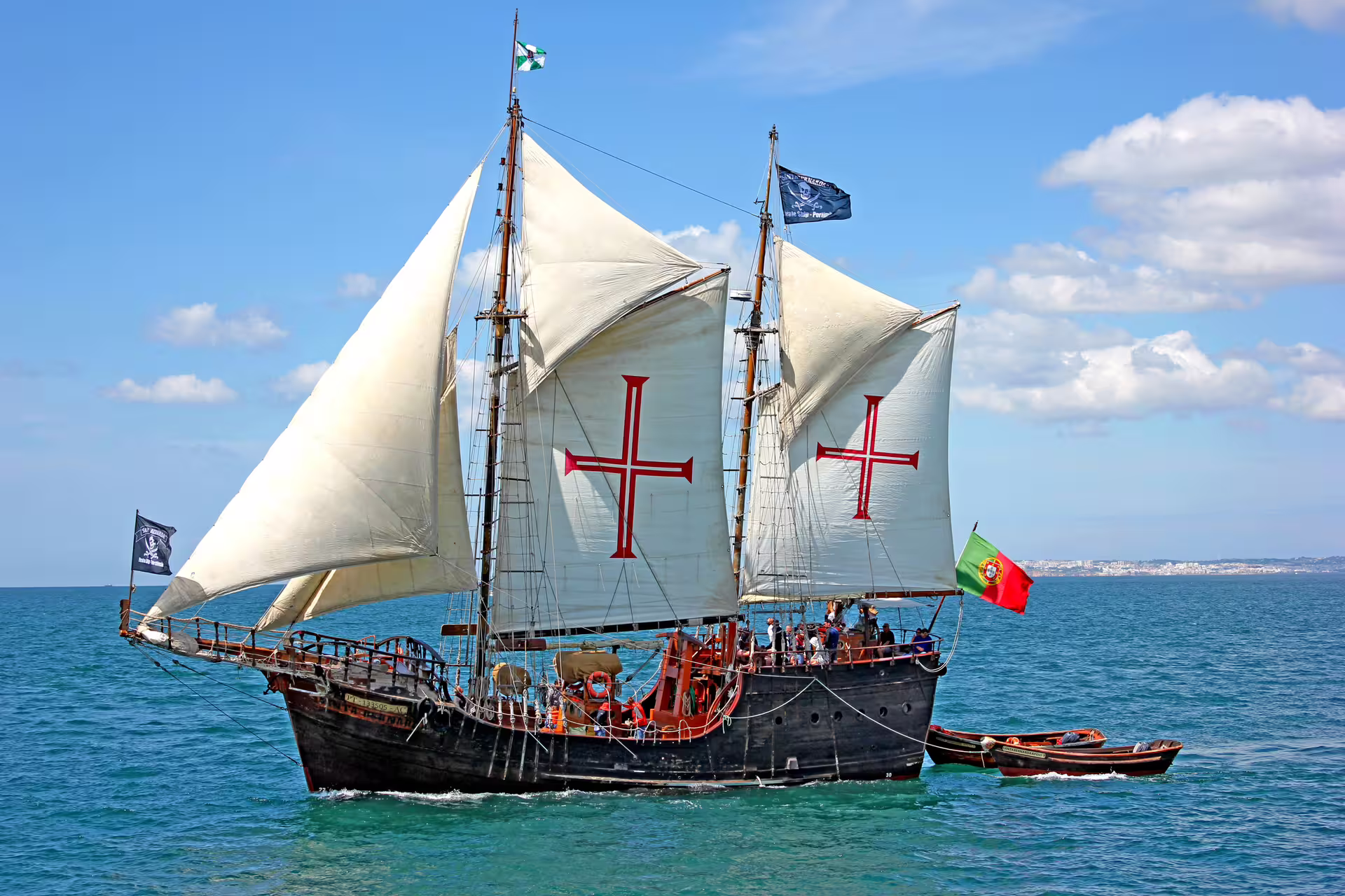 Historic sailing ship with cross sails gliding through turquoise seas on the Lagos-Cape Caves afternoon wind cruise.